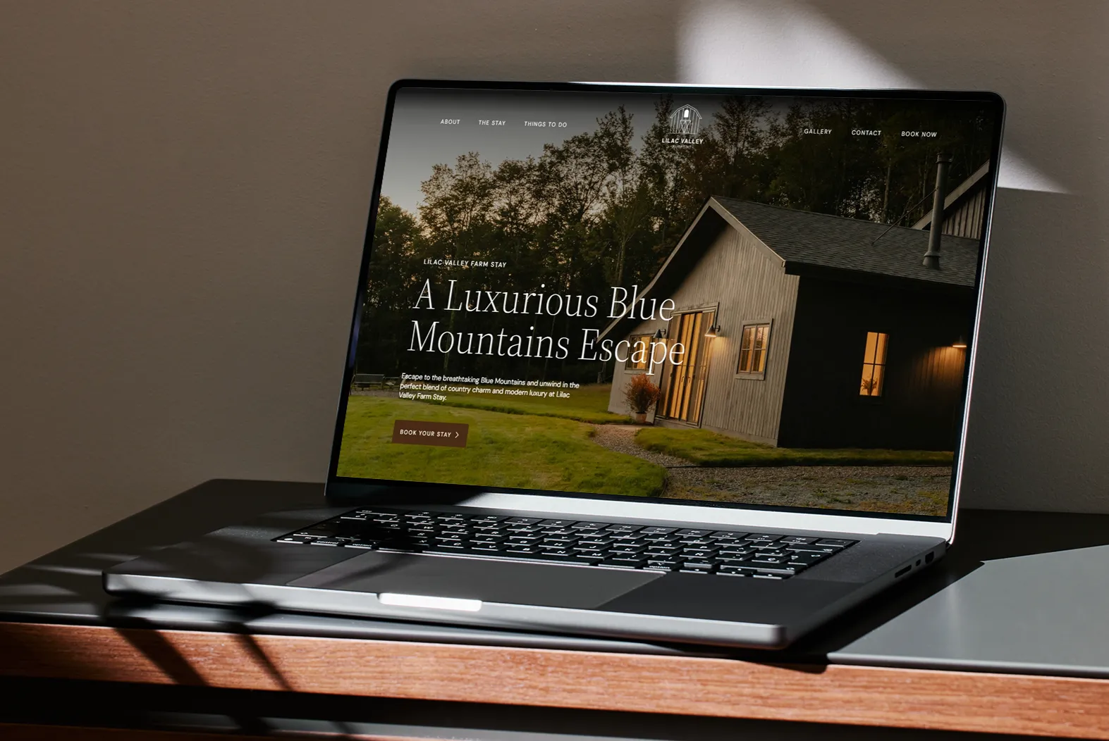 The Lilac Valley Farm Stay website displayed on a laptop